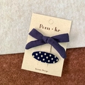 Deep purple bow hair clip and navy blue polka dot oval hairpin set on a display card - Bow + Polka Dots