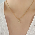 Gold plated titanium steel necklace with zircon-studded letter Z pendant on female model - Letter Z / Gold