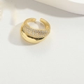Close-up of golden adjustable ring with sparkling zircon pavé and polished metal finish - Clear Zirconia Style