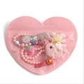 Pink heart-shaped jewelry pouch containing assorted colorful children accessories - 8.5x10cm / Pink