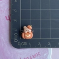 Close-up of mini resin Halloween pumpkin charm with kitten on a measuring mat - Pumpkin Bear