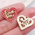 Golden and red enamel heart pendants with I LOVE YOU engraving shown on fingertips - Red ILOVEYOU Hollow Heart (21184)
