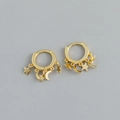 Detail of golden huggie hoop earrings with delicate star and moon dangling charms - Star and Moon Charm Hoop Earrings (S-E1553) / Gold
