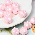 Macro detail of iridescent pink cat paw acrylic beads for DIY jewelry and crafts - Pink