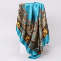Detailed view of paisley silk scarf with satin finish draped over geometric stand - 90x90cm / Blue (D9239)