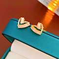 Golden heart-shaped stud earrings with micro-set zircons on a dark green box - Silver Earring Post Gold Zircon Heart Hollow Style(HE10072)