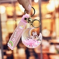 Portachiavi con coniglio e luna rosa con sabbie mobili, ciondolo galleggiante e campanello - Rosa