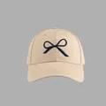 Beige baseball cap with navy blue bow embroidery and premium twill cotton texture - Hard Top Bow Baseball Cap Style / Khaki