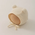 Detailed waffle knit texture on beige baby earflap hat with cute pom-pom ears - 0-12 Months / Beige