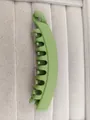 Macro view of matte grass green banana hair clip with multi-teeth grip on velvet tray - Matte Army Green