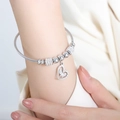 Silver-tone steel wire bracelet with hollow heart pendant and butterfly charm detail - Steel (Z252)