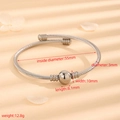 Polished silver stainless steel cable rope cuff bracelet with central metal bead detail - Cable Silver Beads