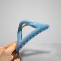 Light blue triangular hair claw clip with marble texture and golden spring detail - Haze Blue