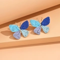 Colorful woven raffia butterfly earrings in bohemian style with gold metal accents - Blue