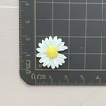2cm white resin daisy flower charm with yellow center on a metric measuring mat - Open Daisy