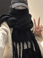 Solid black mohair knit scarf featuring classic tassel edges for a minimalist winter style - Black