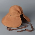 Detail of wide brim straw sun hat featuring a metal logo and dark brown ribbon tie - M(56-58cm) / Orange