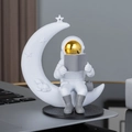 White astronaut figurine sitting on crescent moon reading book with rabbit carving - No.12 Gold Model C