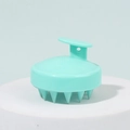 Ergonomic silicone scalp massager brush in mint green with cone-shaped bristles - Green