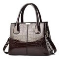 Dark coffee brown glossy patent leather handbag with crocodile pattern and gold hardware - Coffee