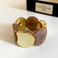 Detailed close-up of wide stretch bracelet with amber marble resin and gold metal discs - Gold-Grey Coffee