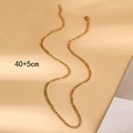 Detail der 18K Gold Figaro-Halskette mit 40+5 cm Längenmaß auf beigefarbenem Hintergrund - Goldene Figaro-Kette