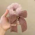 Cute pink plush scrunchie featuring a knitted bow and decorative bear label - Pink Bow Scrunchie