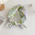 Floral and dot patterned cotton linen square scarf tied in a knot on a white desk - Patchwork Green Floral