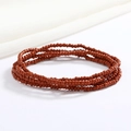 Macro detail of multi-layered reddish-brown glass bead body chain with elastic cord - Brown Red