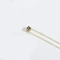 Minimalist golden necklace with a black cube pendant featuring letter W decoration - Letter W