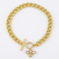 Golden Cuban link bracelet with bee charm and crystal toggle clasp on white background - Little Bee Style