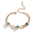 Vergoldetes Edelstahl-Armband mit blauen Teufelsauge-Anhängern und Kordelringen - Gold