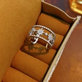 Macro detail of silver double-layered star ring with zircon stones in brown velvet box - Silver
