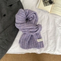 Detailed texture of a soft purple knitted wool scarf with a small woven brand label - love Series / Purple