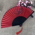 Classic red folding fan with plum blossom pattern, black frame, and red tassel decor - No.36 Red Plum Pattern
