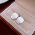 Minimalist silver oval stud earrings with a brushed matte finish shown on a jewelry box - Brushed Matte Silver Oval (62#)