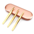 Set of 3 gold precision eyelash tweezers with a rose gold storage case on white background - Titanium Gold 3-Piece Tweezer Set with Rose Gold Aluminum Box