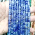 Close-up of blue natural stone spacer beads showing a smooth polished finish and round shapes - Blue Goldstone