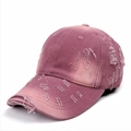 Close-up detail of distressed pink purple washed cotton baseball cap with torn fabric edges - Adjustable / Rose Pink
