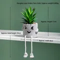 Detailed view of artificial succulent in a cement pot with smiling face and hanging legs - Smile Face Style