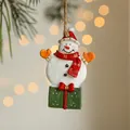 Festive resin snowman pendant with green gift box and red bow for Christmas tree decor - Snowman Gift Pendant