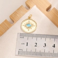 Macro shot of evil eye sunburst pendant in gold finish with size reference scale - E003G