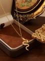 Close-up of a 18k gold snake pendant necklace on a luxury jewelry display box - Striped Small Snake (ZHN2403 Gold)