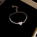Detail of a sparkling heart charm bracelet with gold finish and adjustable slider clasp - Heart-shaped Pave Zirconia Adjustable Style / Gold