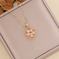 Layered gold necklace with pink zircon flower pendant on a pink leather jewelry box - Pink
