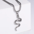 Macro detail of silver stainless steel snake pendant with textured scales and box chain - Necklace / Steel