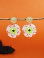Detailed view of Halloween eyeball drop earrings hanging on a branch over orange background - WS10-1 (Eye Design)