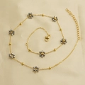 Golden stainless steel chain bracelet with gray faceted bead flowers on beige fabric - Silver Necklace