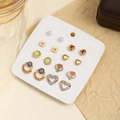 Set of gold twist earrings with pearls and crystals on a white display card - Set 3 (Heart + Pearl)