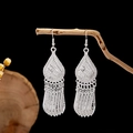 Detail of silver drop earrings with hollow patterns and tassels on a branch - Silver Hollow Rhombus Tassel Style (E2873-24)